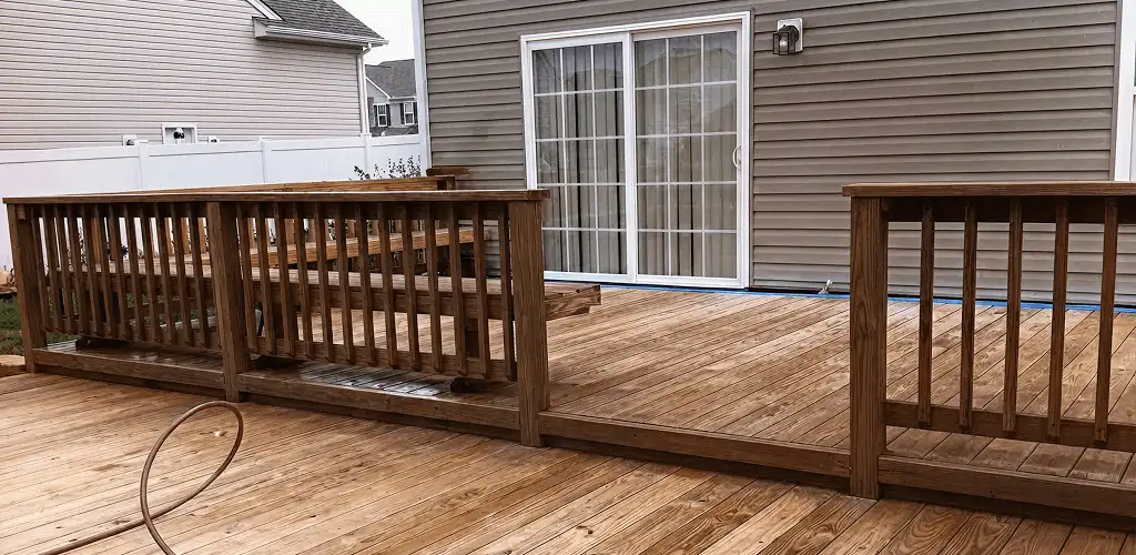 Deck sealing service protecting a backyard wood deck and railings in Fort Collins, CO