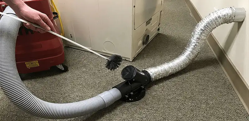 Dryer vent cleaning service removing lint from a dryer duct connection in Fort Collins, CO