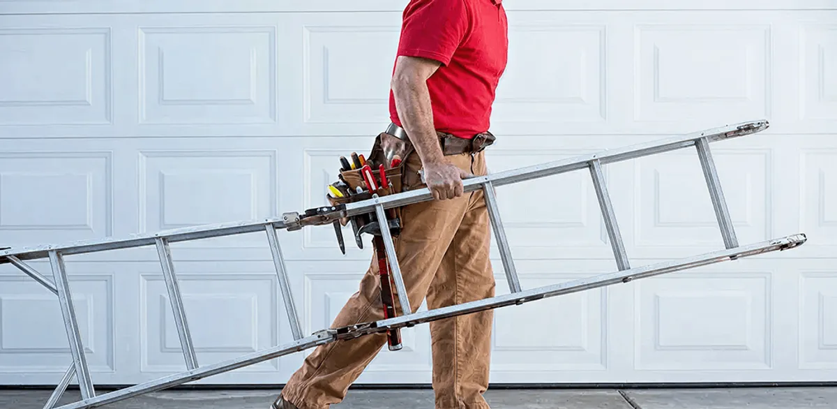 Garage door repair technician arriving with tools and ladder in Fort Collins, CO