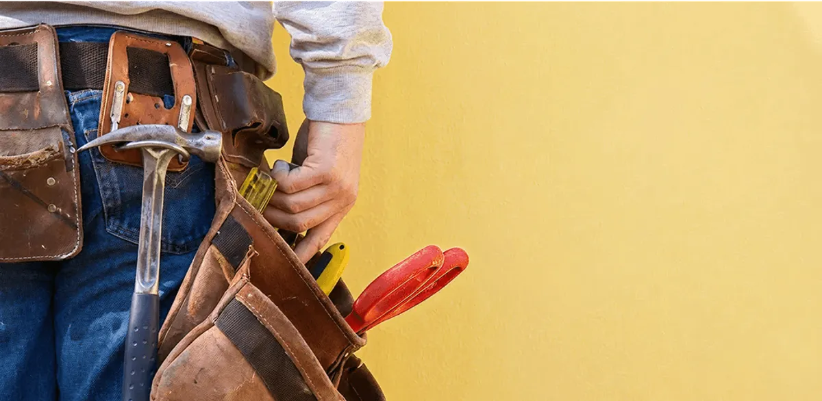 Handyman with tool belt ready for home repairs and maintenance in Fort Collins, CO