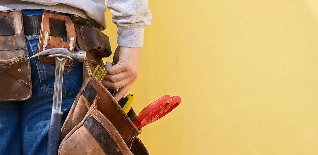 Handyman with tool belt ready for home repairs and maintenance in Fort Collins, CO
