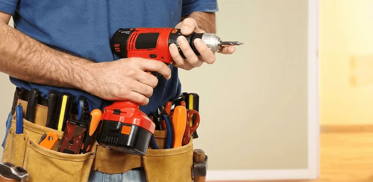 Handyman holding a power drill for home repairs and installations in Fort Collins, CO