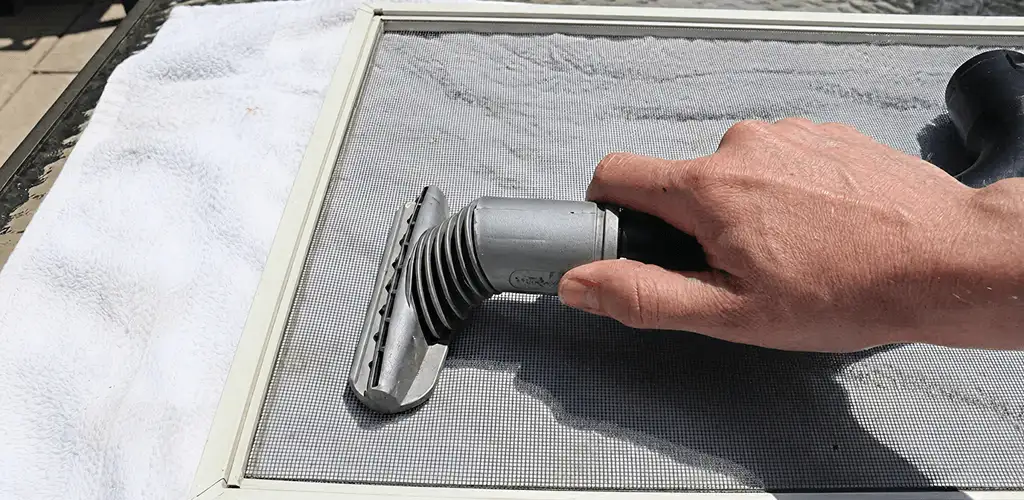 Window screen repair cleaning and fixing a damaged screen mesh in Fort Collins, CO