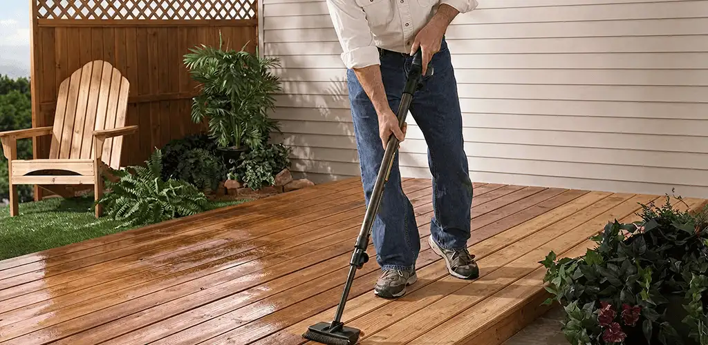 Deck staining service applying stain to a backyard wood deck in Fort Collins, CO